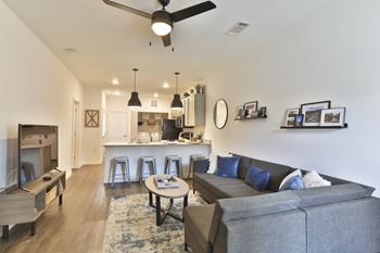 A living room with a grey couch and a coffee table.